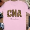 34326775-ec31-444e-8f94-d3b3194b7480 Personalized CNA T-Shirts, Leopard Print Custom Name Nurse T-Shirt, Certified Nursing Assistant Appreciation Gift, Christine Name Tee