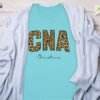 4563d7b2-9748-4b22-9b4e-386013dd9595 Personalized CNA T-Shirts, Leopard Print Custom Name Nurse T-Shirt, Certified Nursing Assistant Appreciation Gift, Christine Name Tee